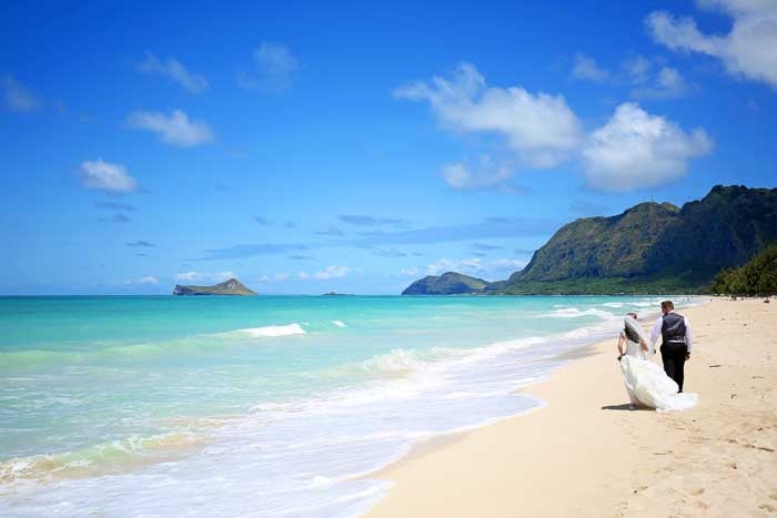 Hawaii elopement couple at the beach Hawaii elopement couple walking down the beach