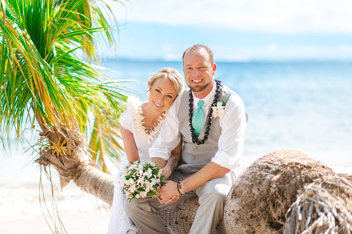 A Hawaii wedding couple posing at Waialae Beach