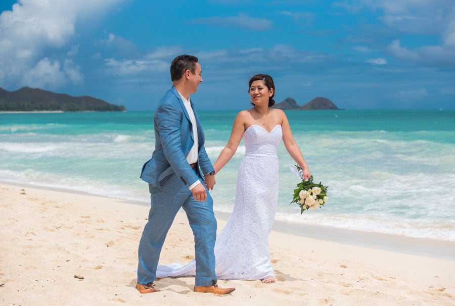 A bride wearing a strapless wedding dress on the beach