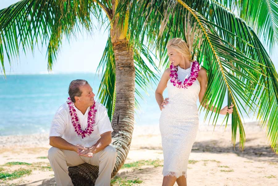 A bride and groom on the beach in Hawaii
