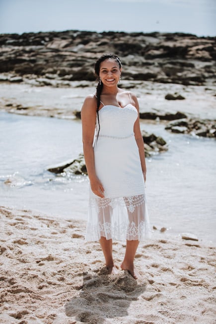 A bride in Hawaii wearing a casual wedding dress