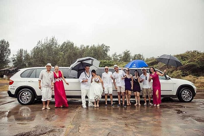 Arriving to a rainy beach wedding