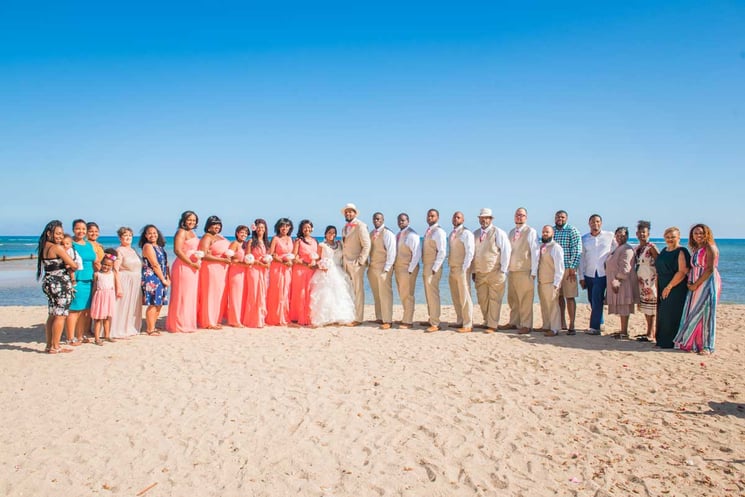 Hawaii beach wedding group photo of couple with all their friends and family