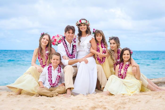 Purple orchid leis for the family at Hawaii beach vow renewal 