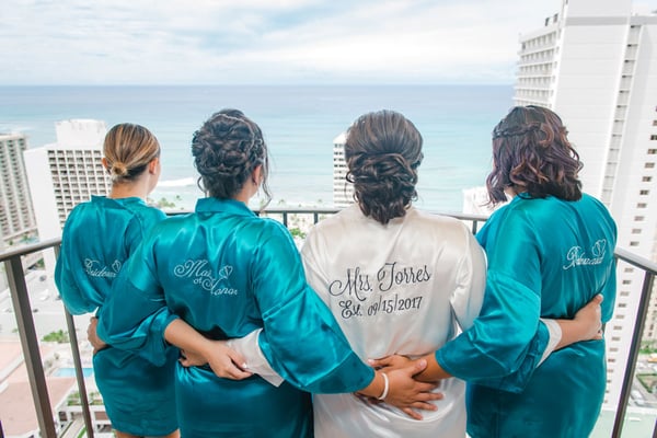 Bridal party standing on a balcony in Hawaii