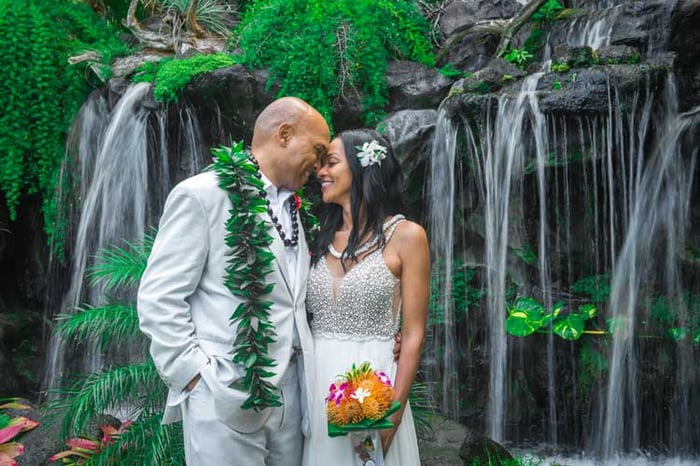 Groom's maile lei and bride's tropical bouquet for wedding at Pukalani Falls