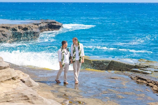 Two grooms at Heaven's point for their cliffside shoot in Hawaii