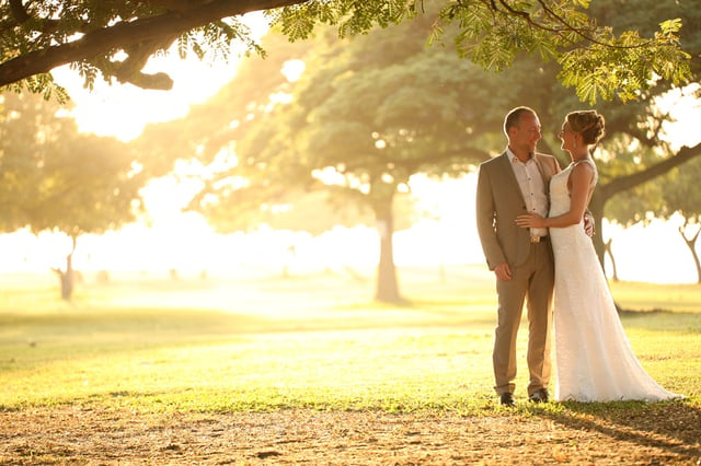 Getting married at their sunset wedding at Magic Island, Hawaii